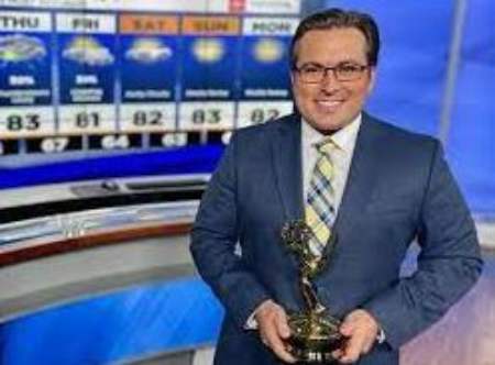 Bryan Bachman with his emmy